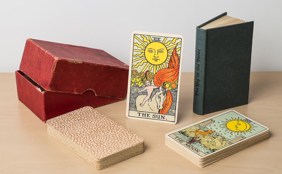 1930's Rider tarot deck displayed with book and box